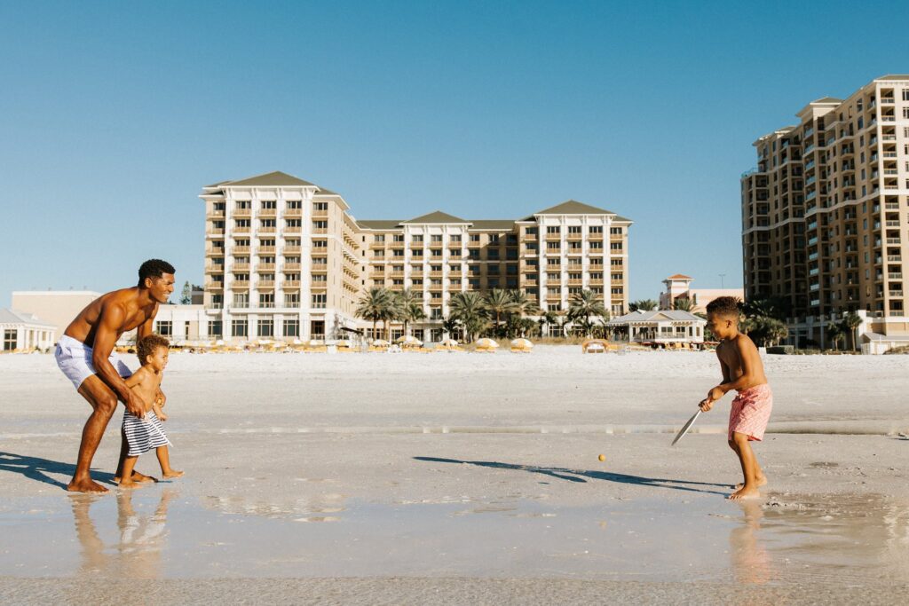2 kids and dad playing on the beach