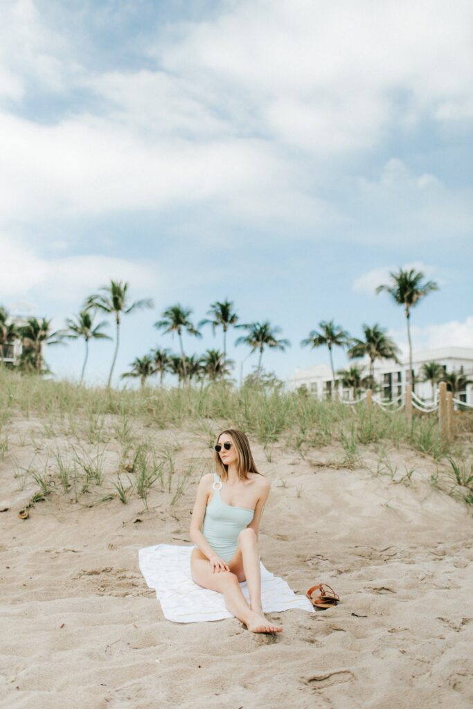 woman laying on a beach in delray