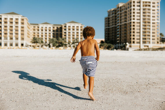 Little boy playing on Sandpearl Resort beach