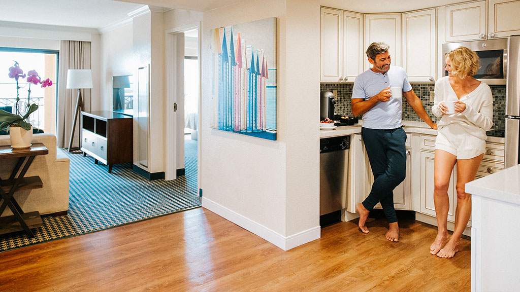 A couple laughs in a suite at The Atlantic Suites on The Ave.