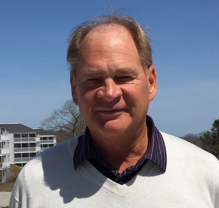 A photo of Gary Soule with the resort in the background.