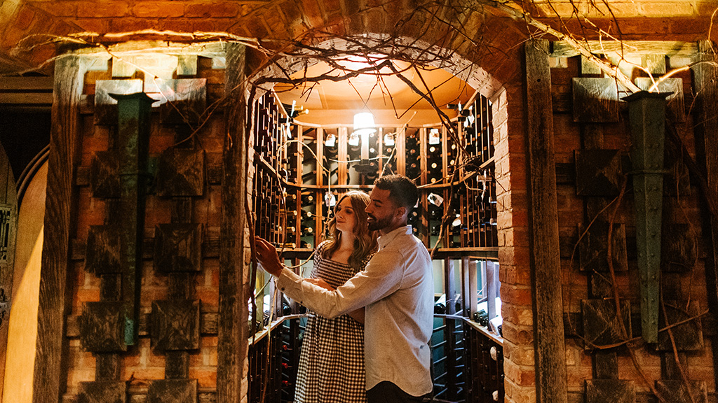 A couple looks at bottles in the wine cellar at Lake Placid Lodge.