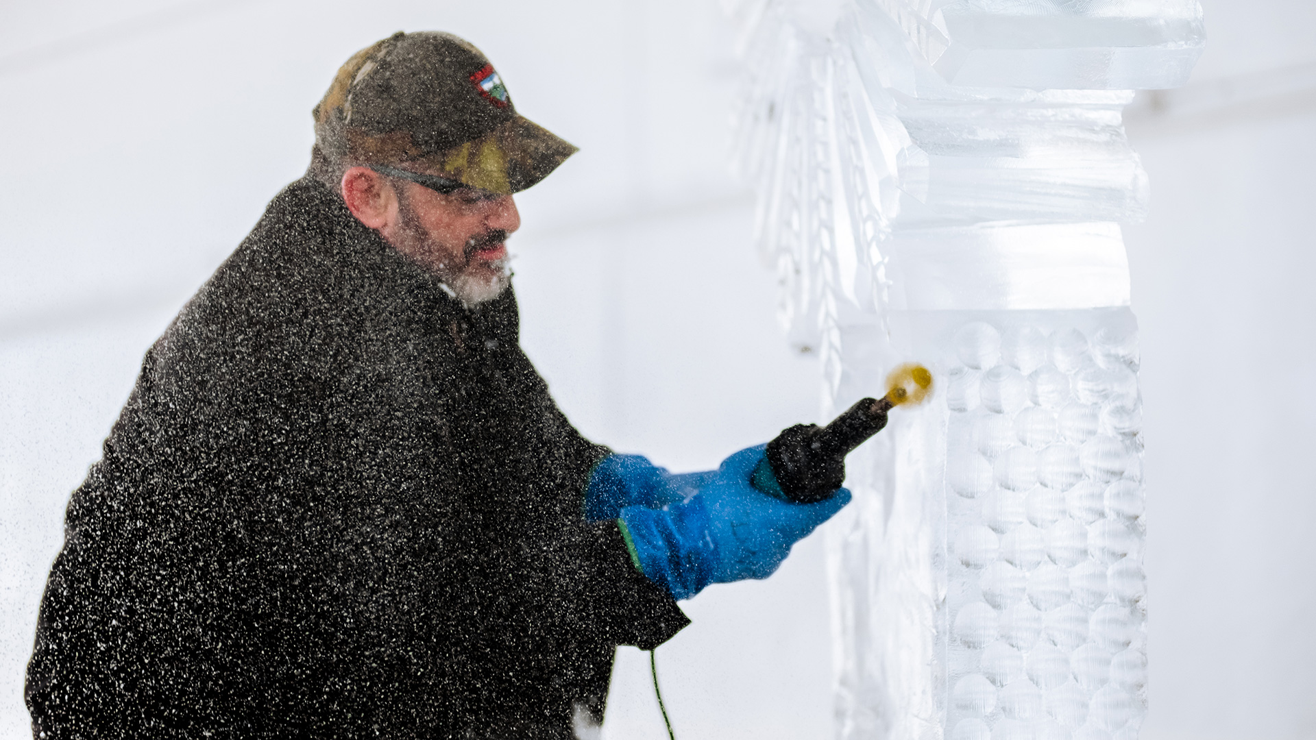 A man sculpts a hunk of ice.