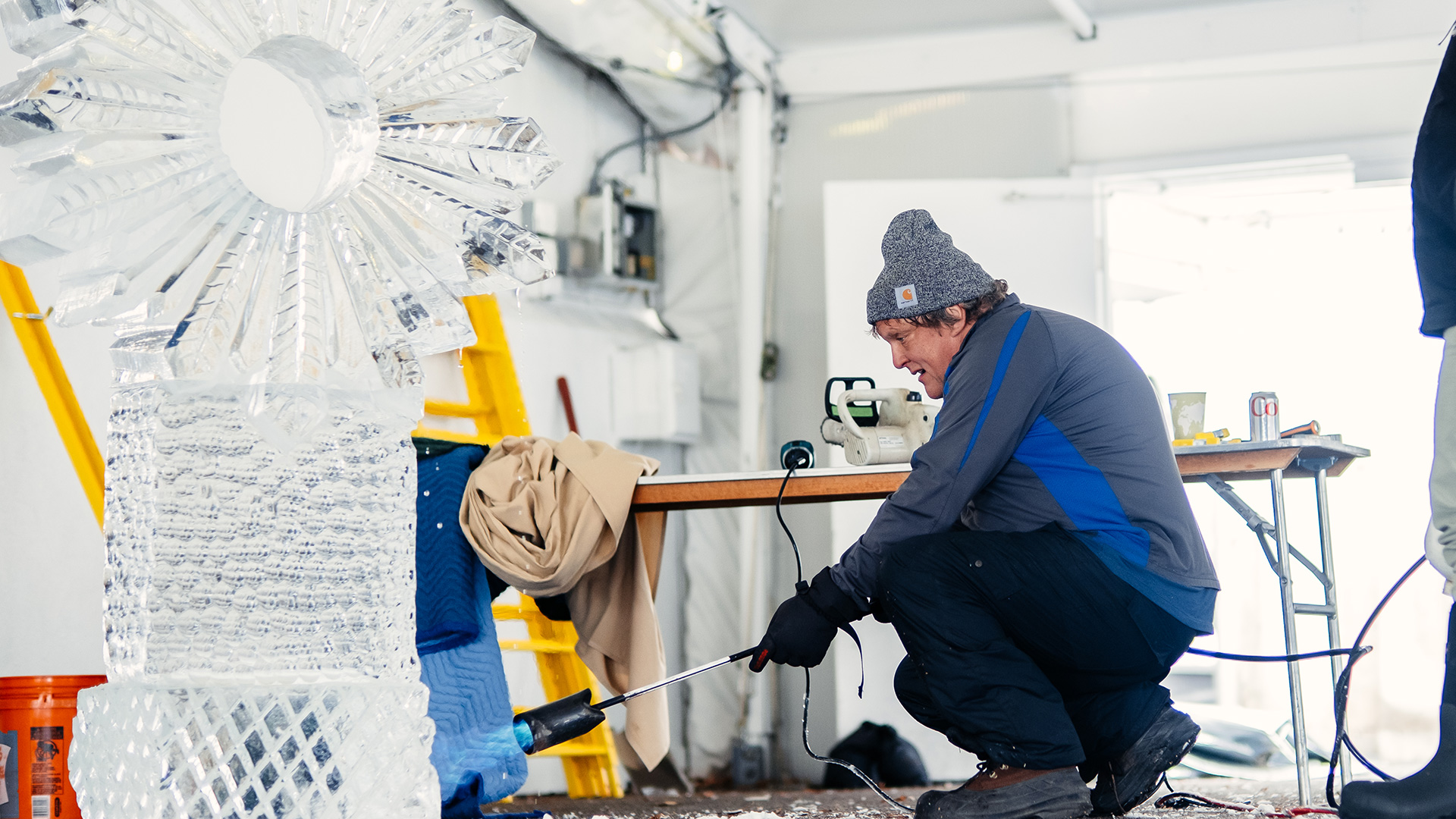 A man sculpts a hunk of ice.