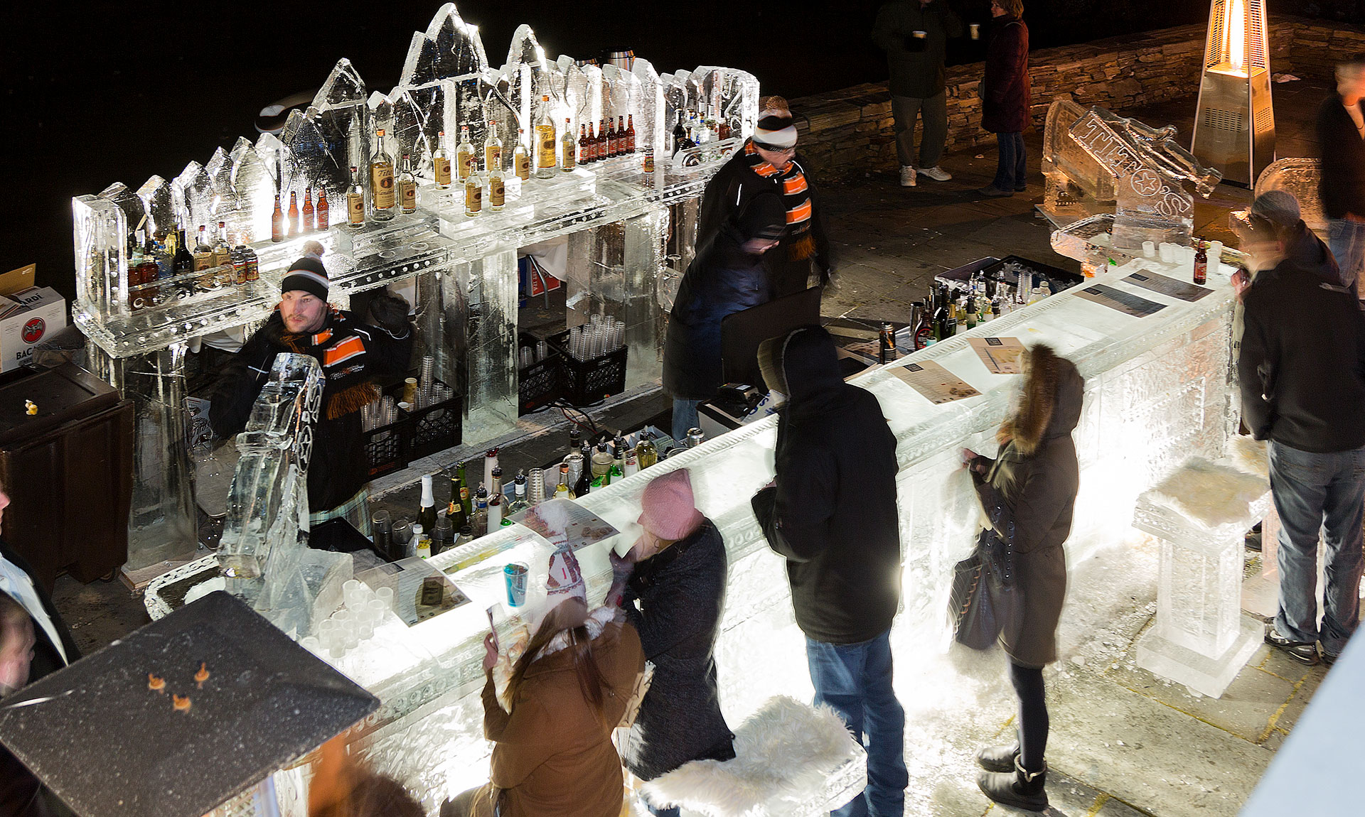Bartenders sling drinks at the annual Glacier ice bar.