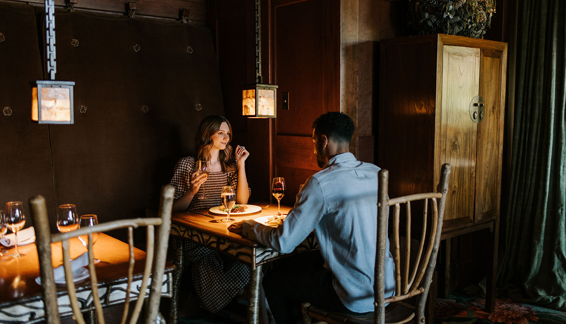 A couple dines in Artisans at Lake Placid Lodge