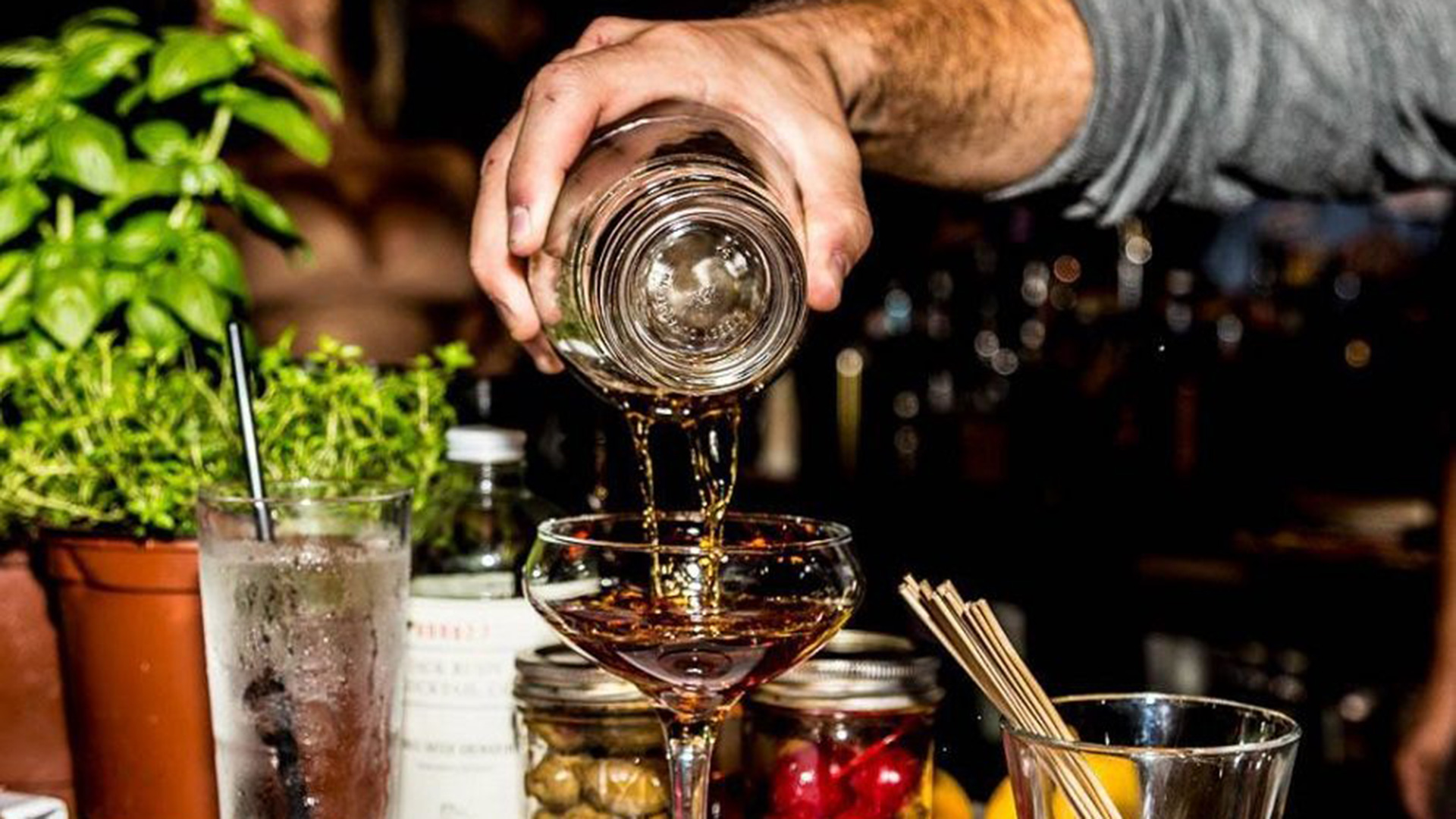 A bartender makes a drink at Honey in Delray.