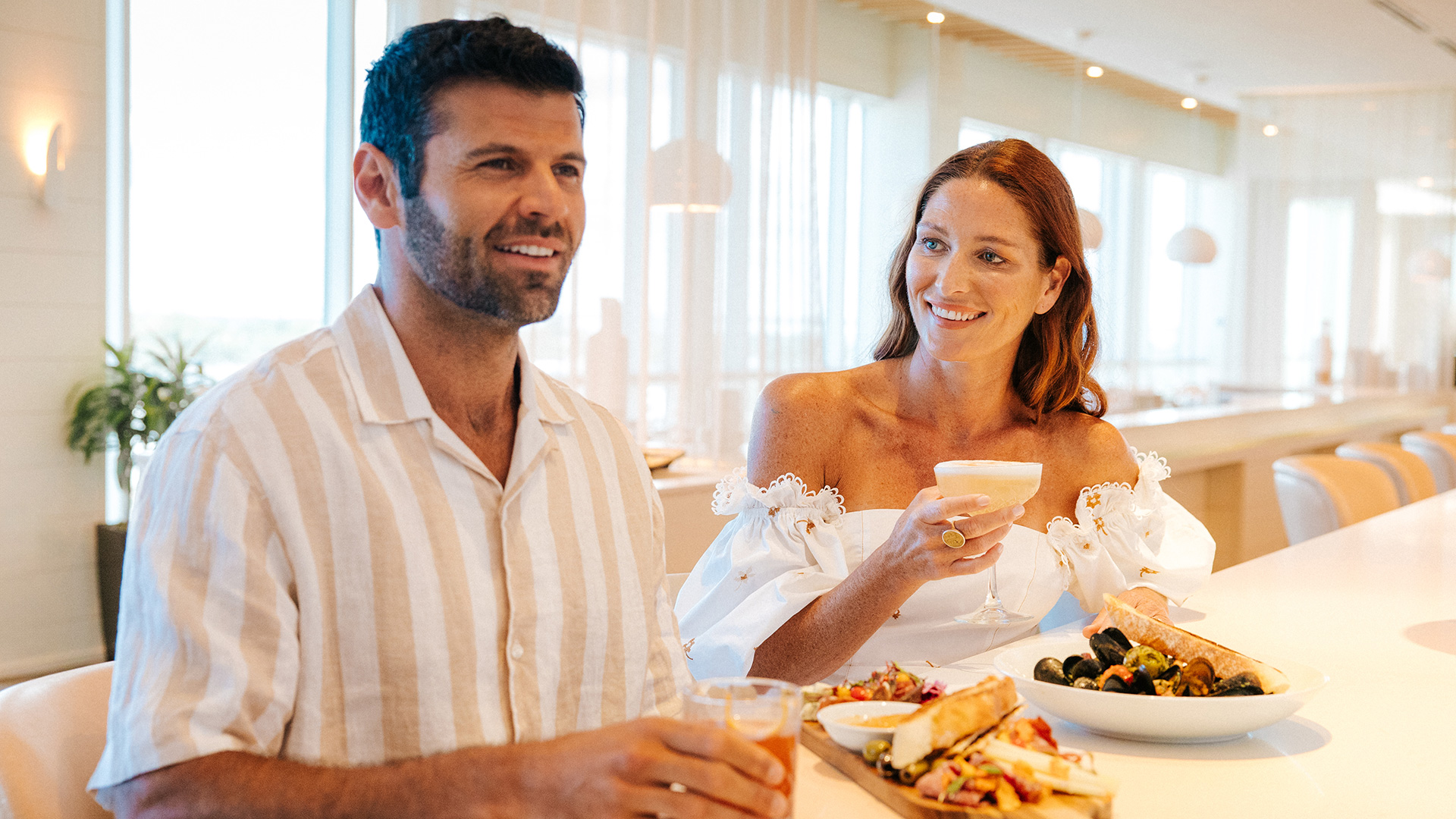 A couple dines at Drift Kitchen & Bar at Lido Beach Resort.