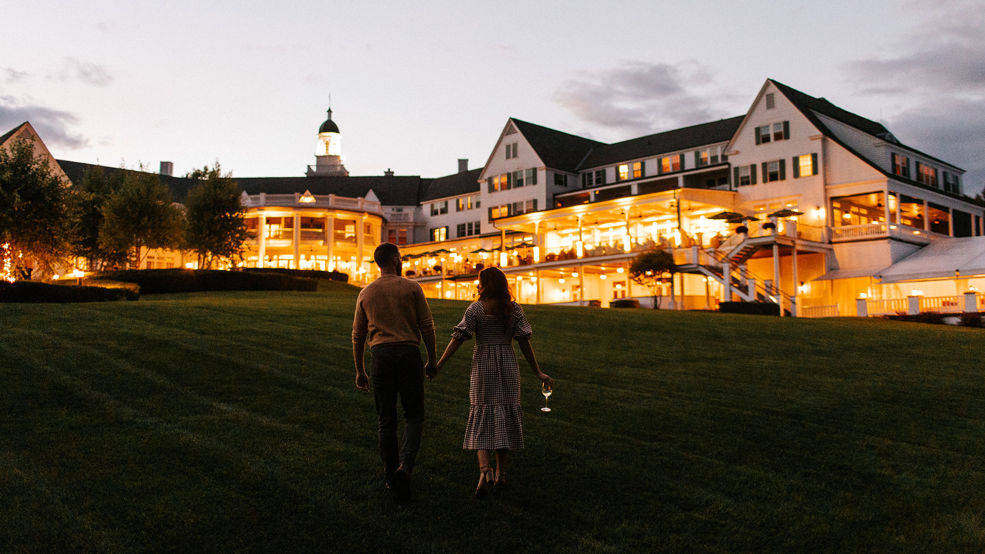 A couple walks up to The Sagamore at night.