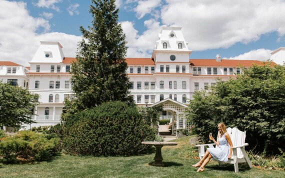 A woman sits in the gardens at Wentworth by the Sea in New Castle, New Hampshire.