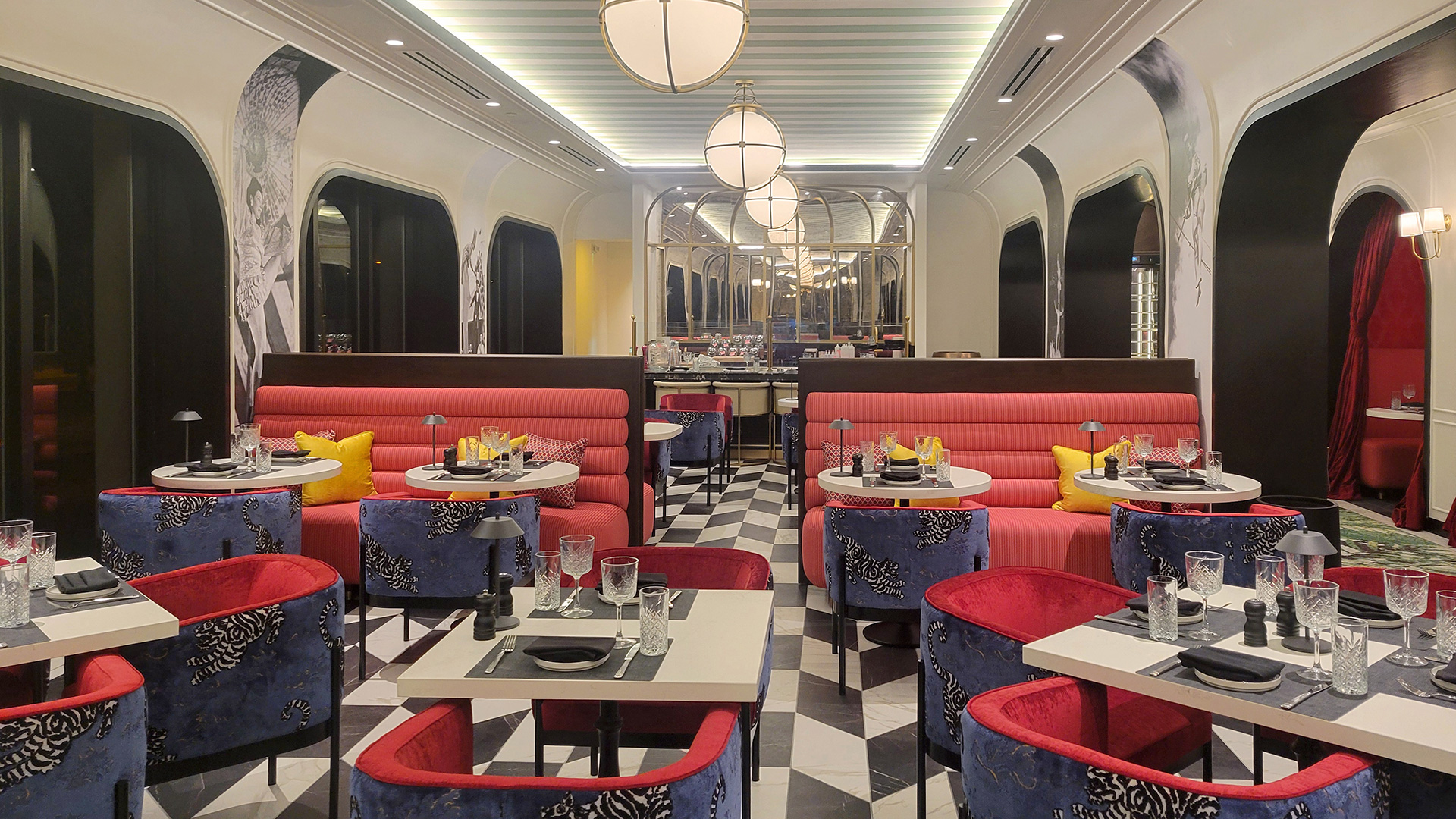 Ringside at Cirque St. Armands Beachside dining room with red banquettes and blue patterned chairs.