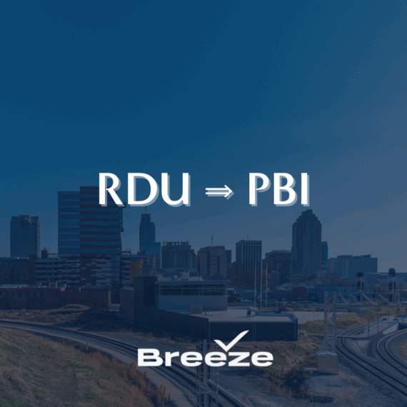 Skyline of a city with train tracks in the foreground. Overlaid text reads RDU ⇒ PBI and Breeze, indicating a flight route from Raleigh-Durham to West Palm Beach by Breeze Airways.