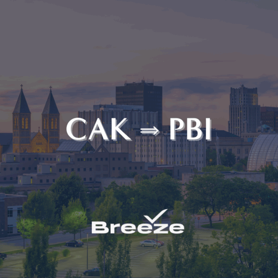 Downtown skyline at sunset with CAK ⇛ PBI in large text and the Breeze Airways logo below, indicating a flight route.