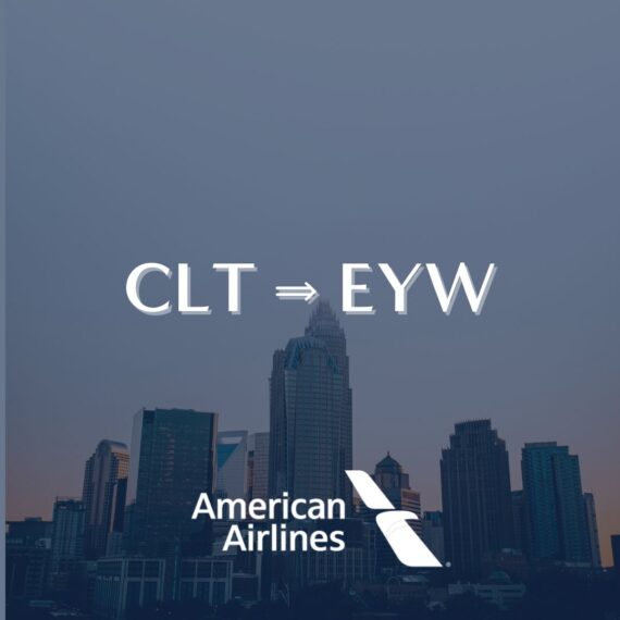 A city skyline at dusk with CLT ⇒ EYW in large text above the American Airlines logo, indicating a flight from Charlotte to Key West.