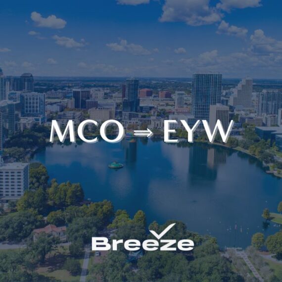 A city skyline and lake view with the text MCO ⇒ EYW in the center and the Breeze airline logo at the bottom.