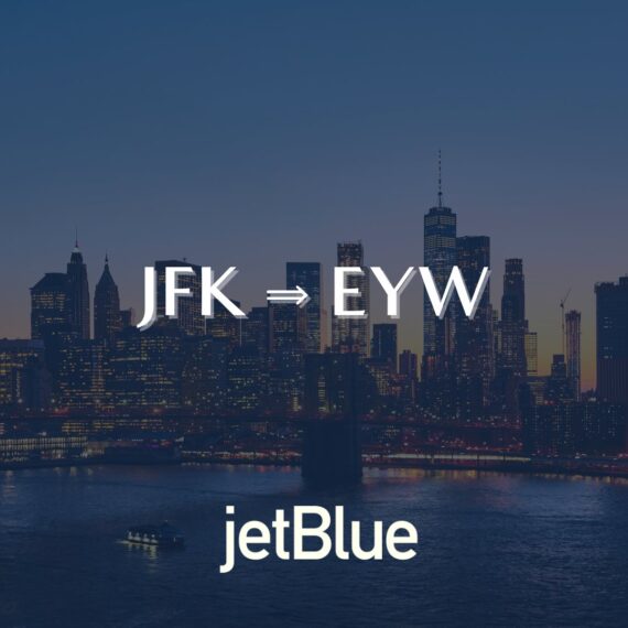 Text “JFK ⇒ EYW” over a city skyline at dusk, with “jetBlue” written at the bottom; representing a flight route from New York JFK to Key West EYW with jetBlue.