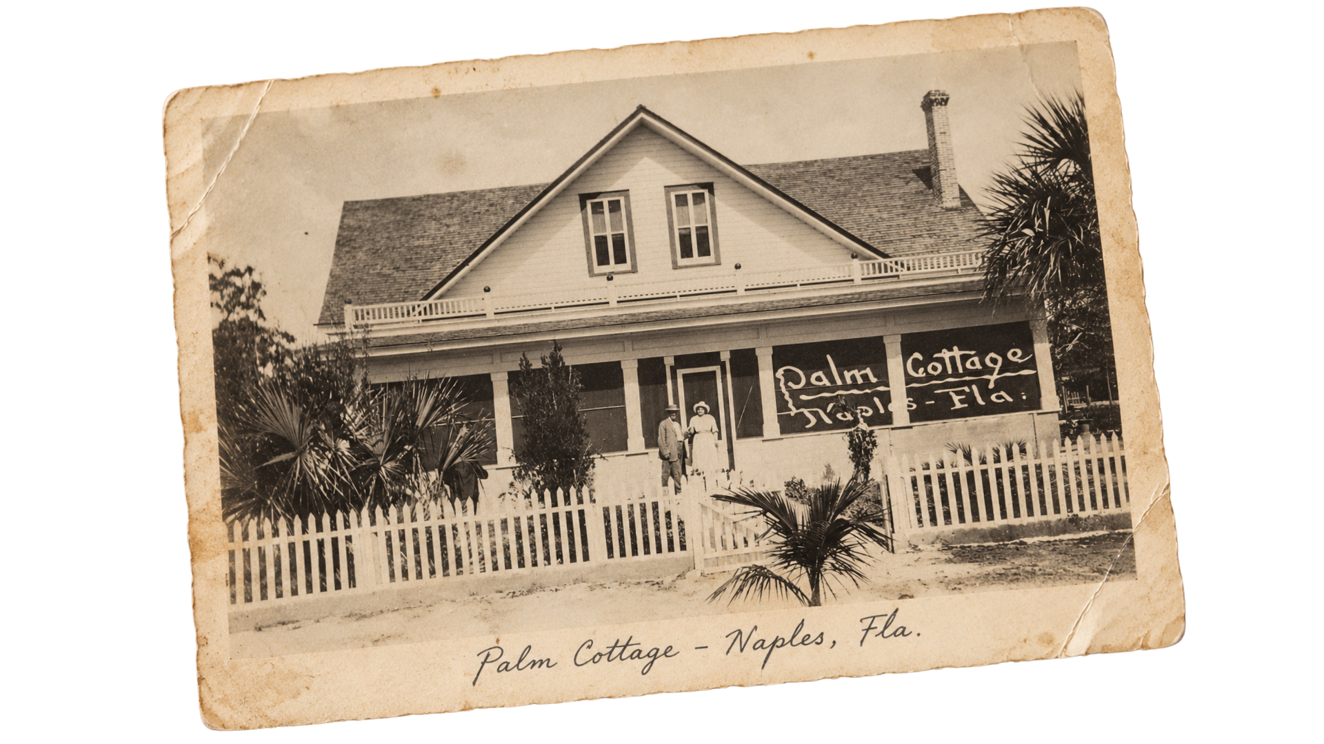 A vintage photo postcard showing Palm Cottage in Naples, Florida. The wooden house has a porch, white picket fence, and palm trees in front. Handwritten text labels the cottage and location.