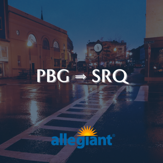 A dimly lit street scene with a crosswalk in front of a small town intersection. The text PBG ⇒ SRQ is centered above the Allegiant logo, featuring a sunburst design.