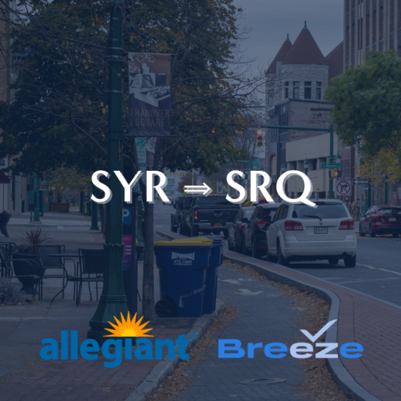 A street scene with parked cars and autumn trees. Text overlay reads SYR ⇒ SRQ with logos for Allegiant and Breeze airlines below.