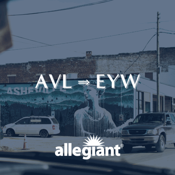 A street scene with cars and a large mural of a person on a building. Text reads AVL ⇒ EYW and allegiant® over the image. The mural has ASHEVI visible on it, hinting at Asheville.
