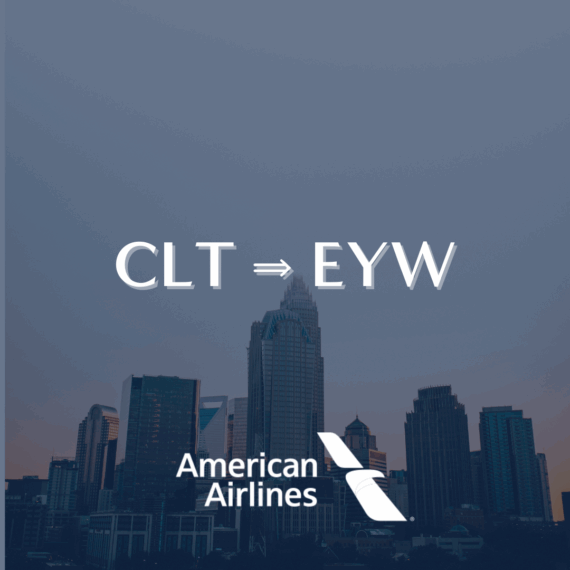 The image shows a city skyline at dusk with the text CLT ⇒ EYW above the American Airlines logo, indicating a flight route from Charlotte to Key West.