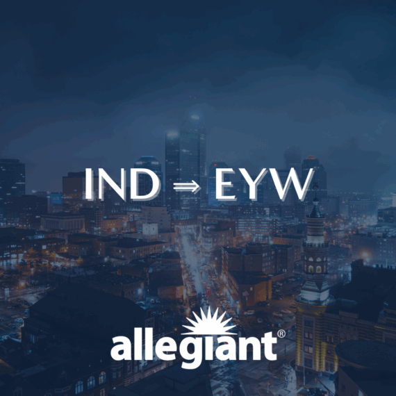 Nighttime cityscape with illuminated buildings. White text reads IND ⇒ EYW above the Allegiant airline logo, featuring a stylized sunburst.