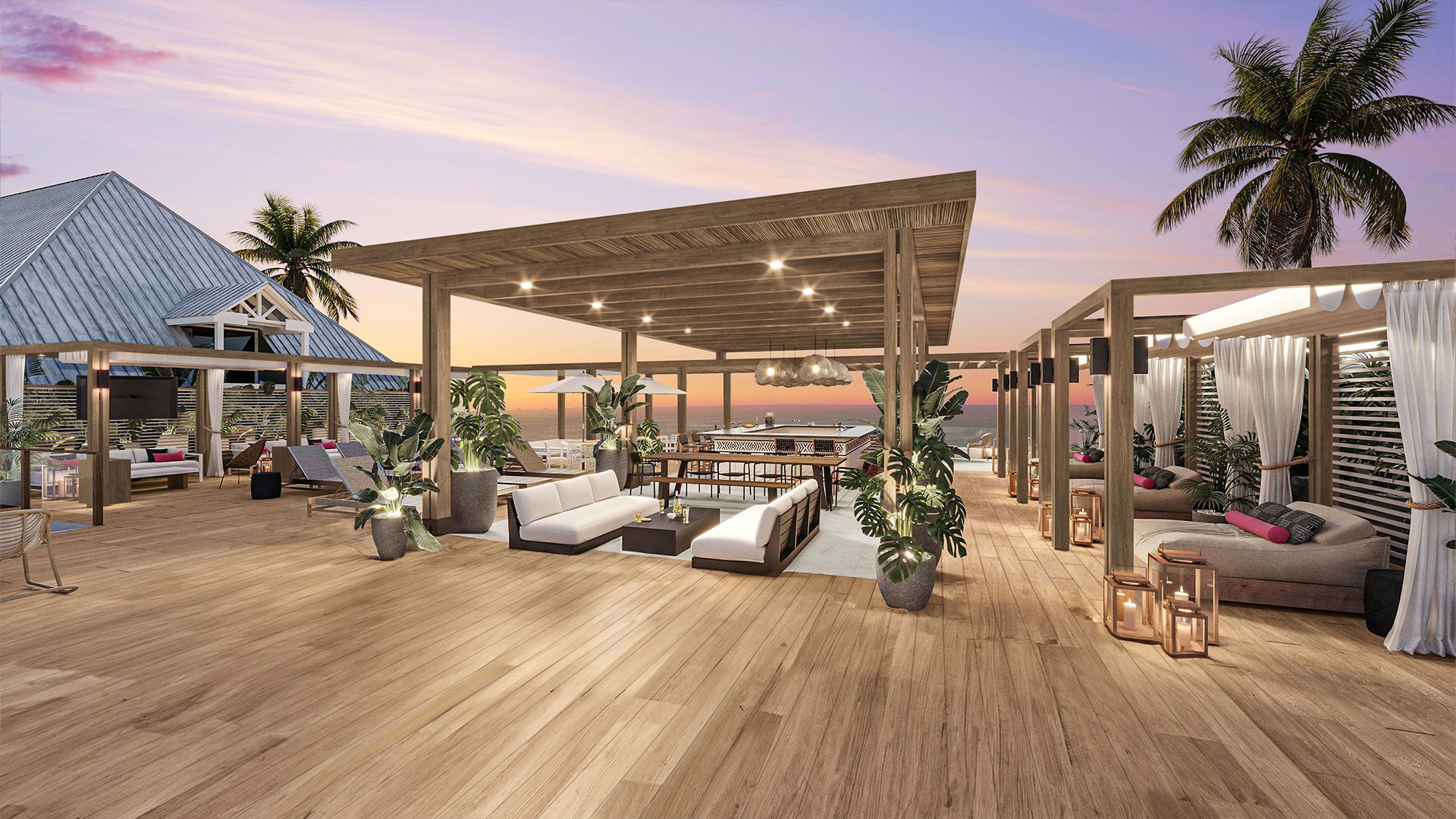 A spacious wooden deck with lounge seating and a pergola overlooks the ocean at sunset. Palm trees, potted plants, and soft lighting create a relaxing, tropical atmosphere. White curtains and cozy furnishings enhance the inviting setting.
