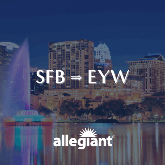 Nighttime cityscape with illuminated buildings and a colorful fountain in the foreground. Overlaid text reads SFB → EYW above the Allegiant logo, indicating a flight route.