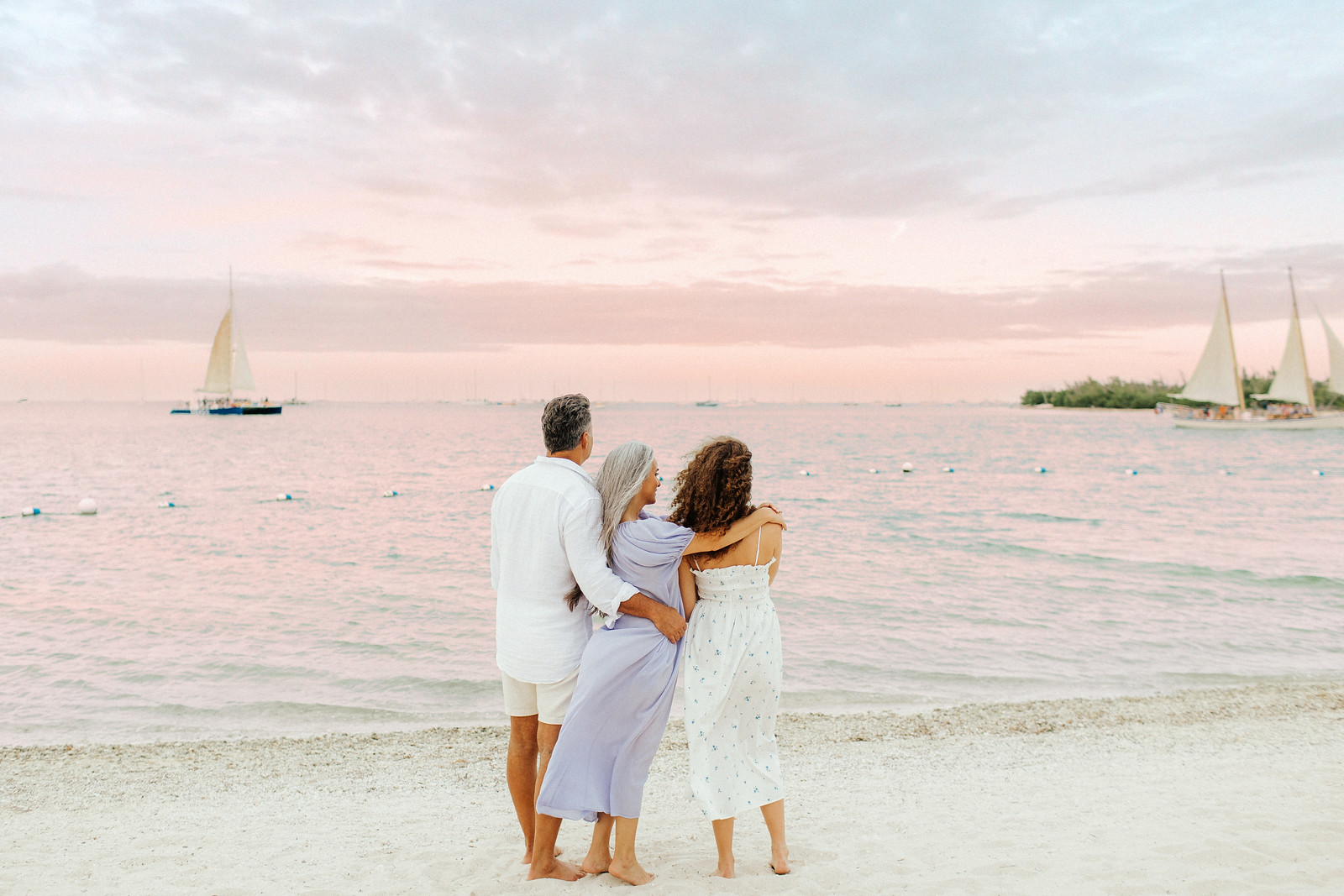 family enjoying sunset on the beach