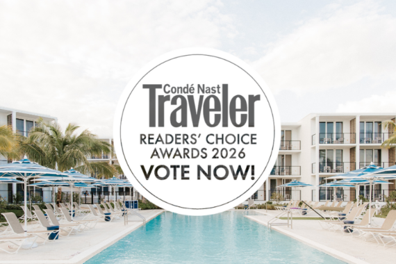 A resort pool area with lounge chairs and umbrellas, framed by palm trees and modern buildings. A circular overlay reads: Condé Nast Traveler Readers’ Choice Awards 2026 Vote Now!.
