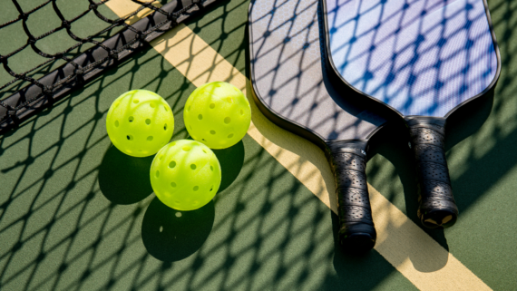 two pickle bowl racquets and 3 balls