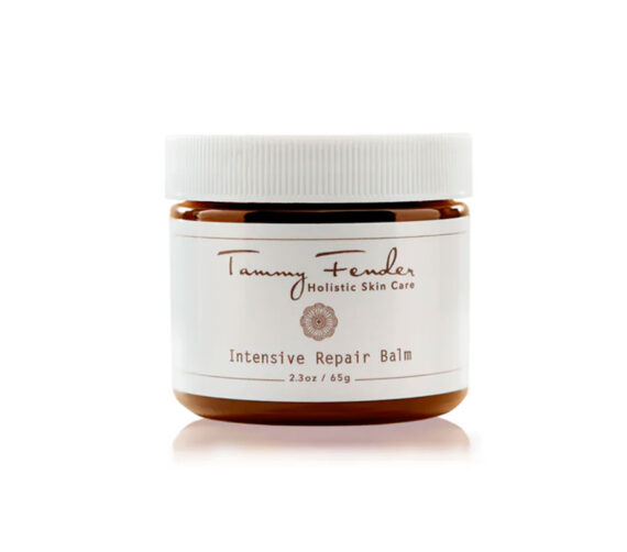 A brown jar with a white lid labeled Tammy Fender Holistic Skin Care Intensive Repair Balm, 2.3 oz / 65 g. The label features minimalist text and a small floral emblem.