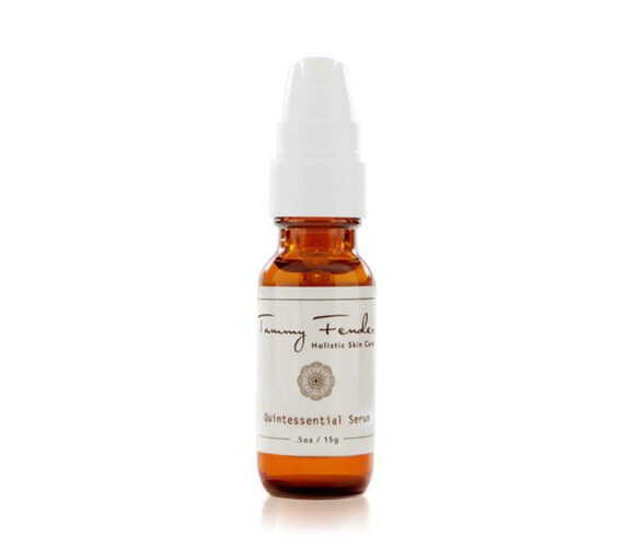 A small amber bottle with a white pump dispenser and label. The label reads Tammy Fender Holistic Skin Care Quintessential Serum .5oz / 15g.