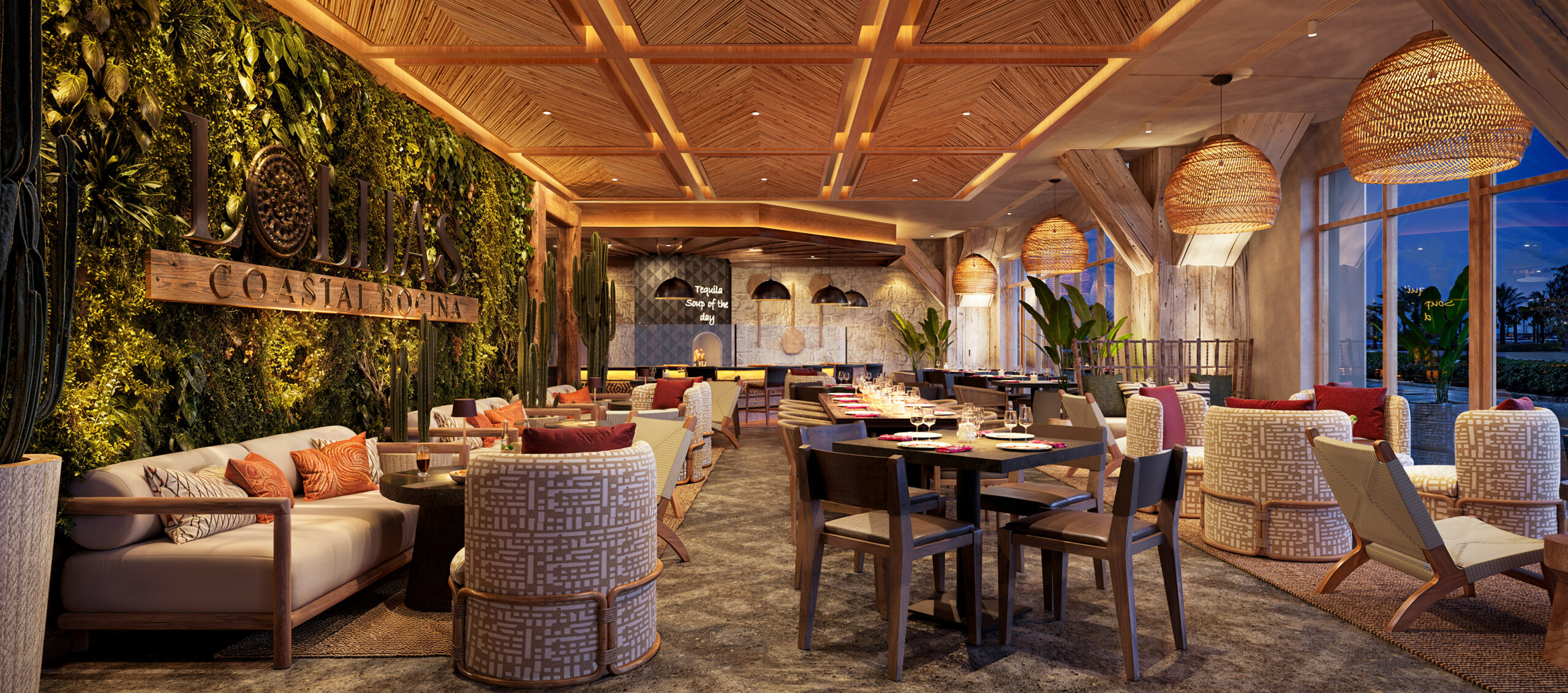 A stylish, tropical-themed restaurant interior with woven light fixtures, green plant wall, wooden ceiling, elegant tables, cushioned chairs, and large windows showing a scenic evening view.