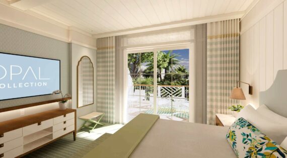 A bright, modern hotel room with light-colored decor, a large bed, a flat-screen TV, and glass doors leading to a balcony with a view of palm trees and blue sky.