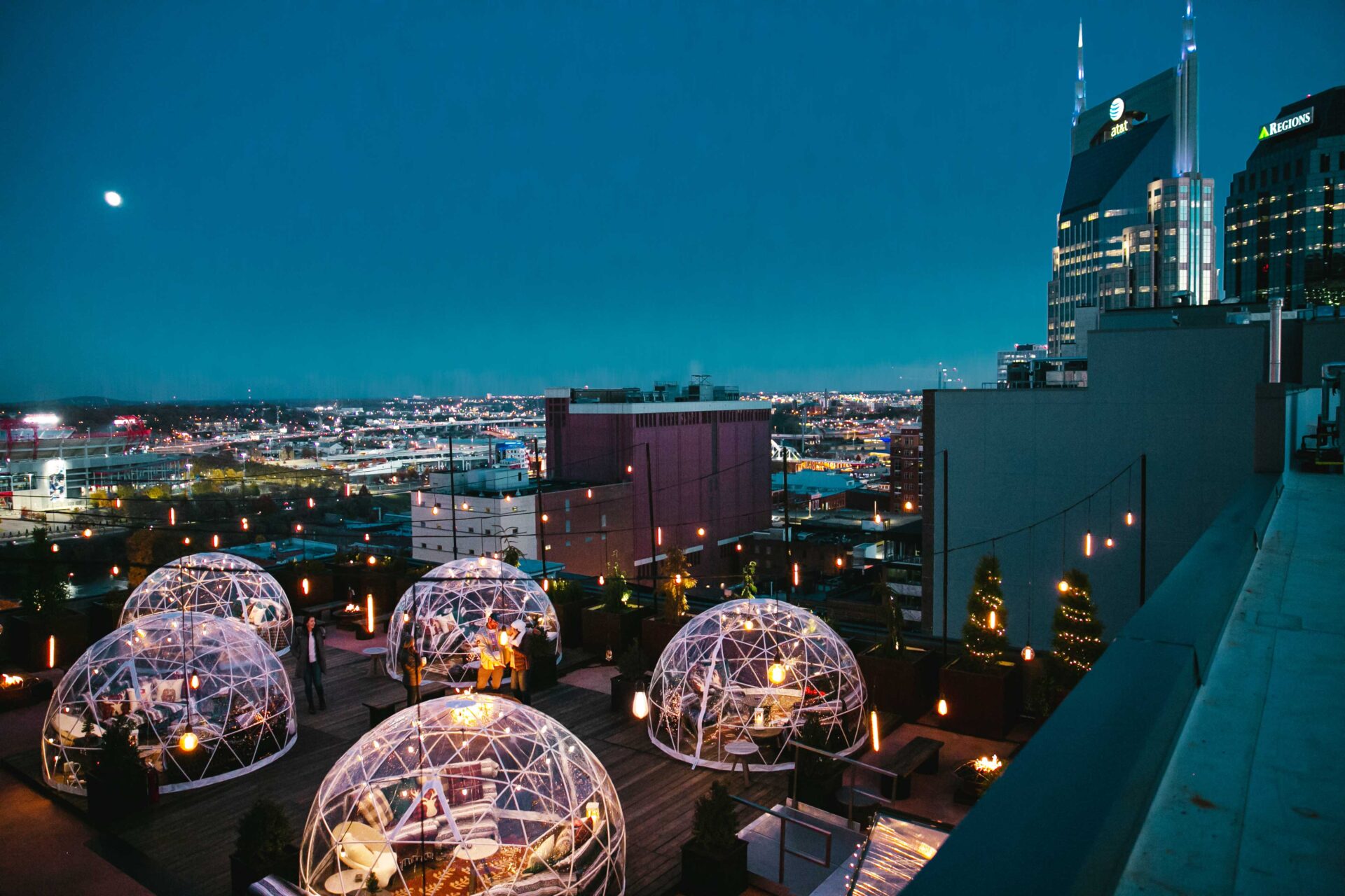 A series of igloos set against the Nashville night sky on the rooftop at Bobby Nashville