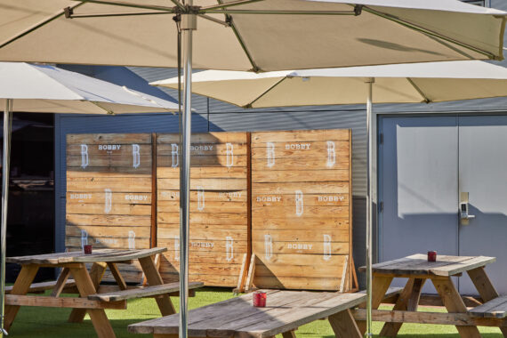 Tables and umbrellas made for shaded seating atop Bobby's Rooftop Lounge