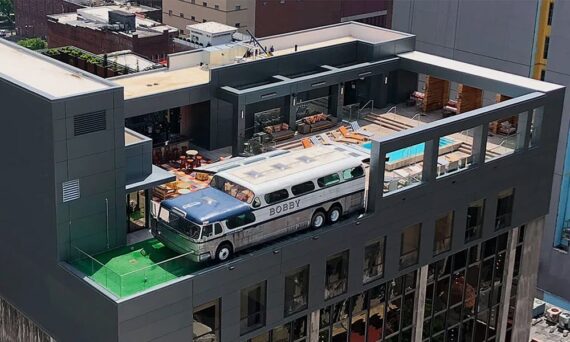 Aerial view of the rooftop pool and a custom Greyhound Scenicruiser bus atop Bobby Nashville.