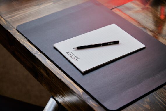 Bobby notebook and pen sitting on a table at a meeting venue at Bobby Nashville.
