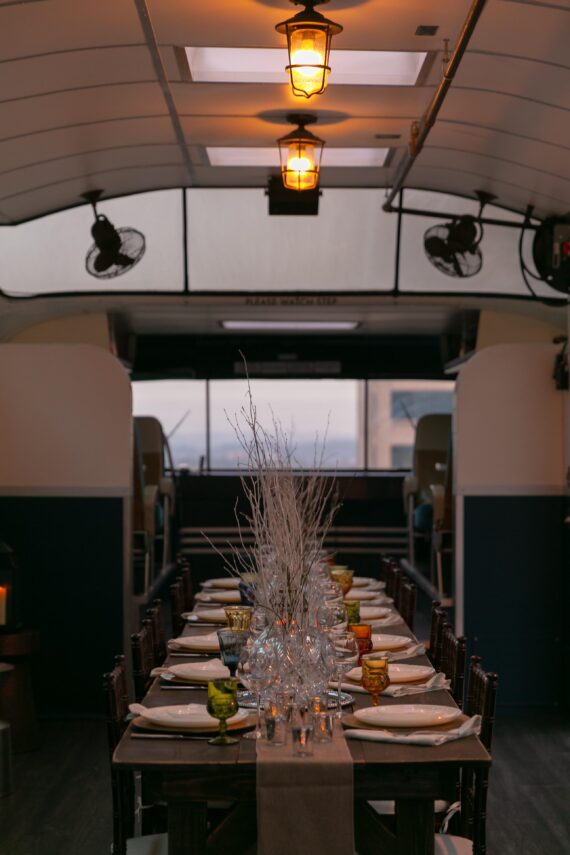 Vertical shot showing a function table set up in the Greyhound Scenicruiser that sits atop the Bobby Hotel Rooftop in Nashville.