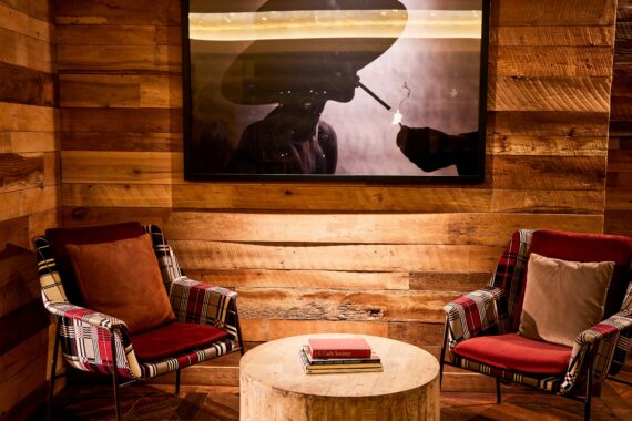 Sitting area at Bobby Nashville featuring framed art work on the walls.