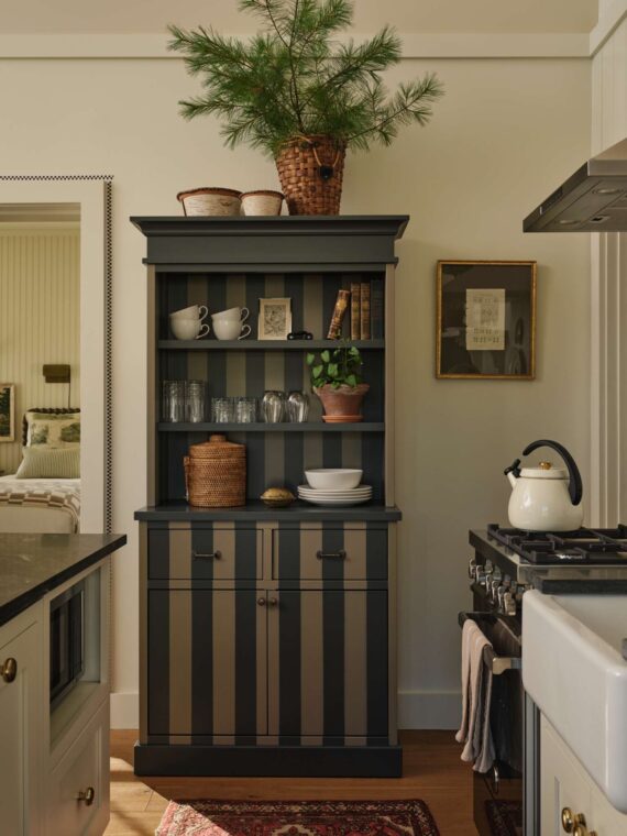 Decorative glassware and plates displayed in one of the Harborside Cottages at The Asticou.