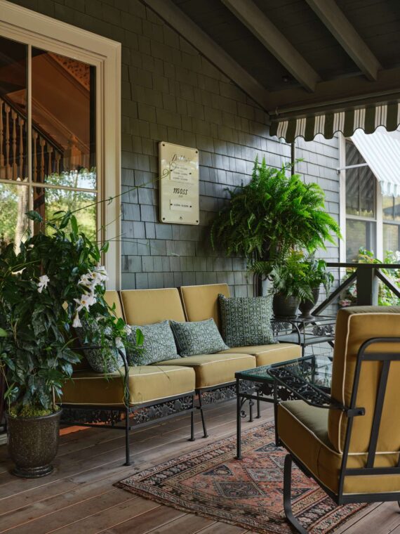 A porch with furniture just outside the lobby of The Asticou.
