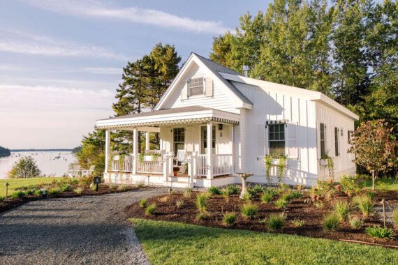 The exterior of one one the Harborside Cottages at The Asticou with the harbor in the background.