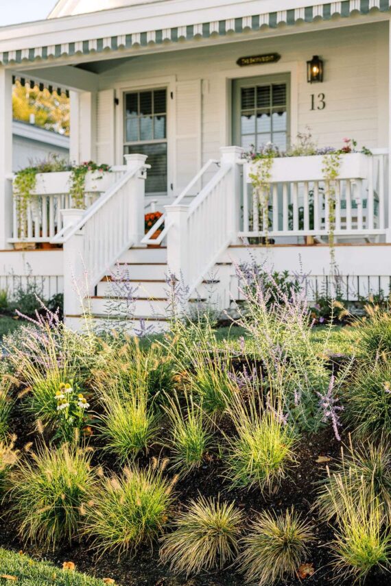 Flowers bloom in front of the entrance of one the Harborside Cottages at The Asticou.