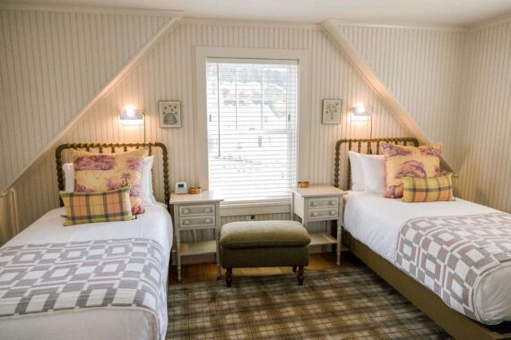 Two twin beds in one of the guestroom accommodations at The Asticou.