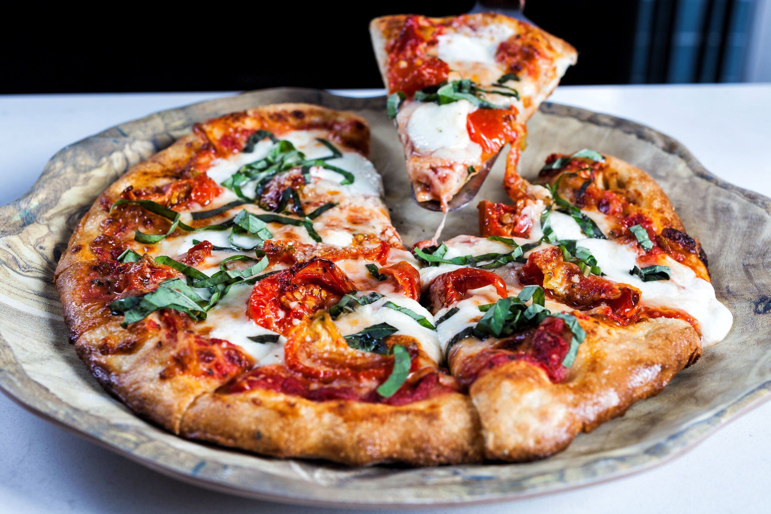 pizza with a slice being pulled up