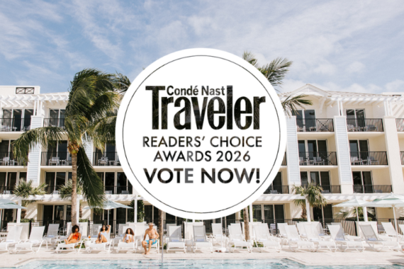 A stylish white resort with palm trees and balconies is seen behind a pool with people relaxing. A large circular overlay announces Condé Nast Traveler Readers Choice Awards 2026 Vote Now!.